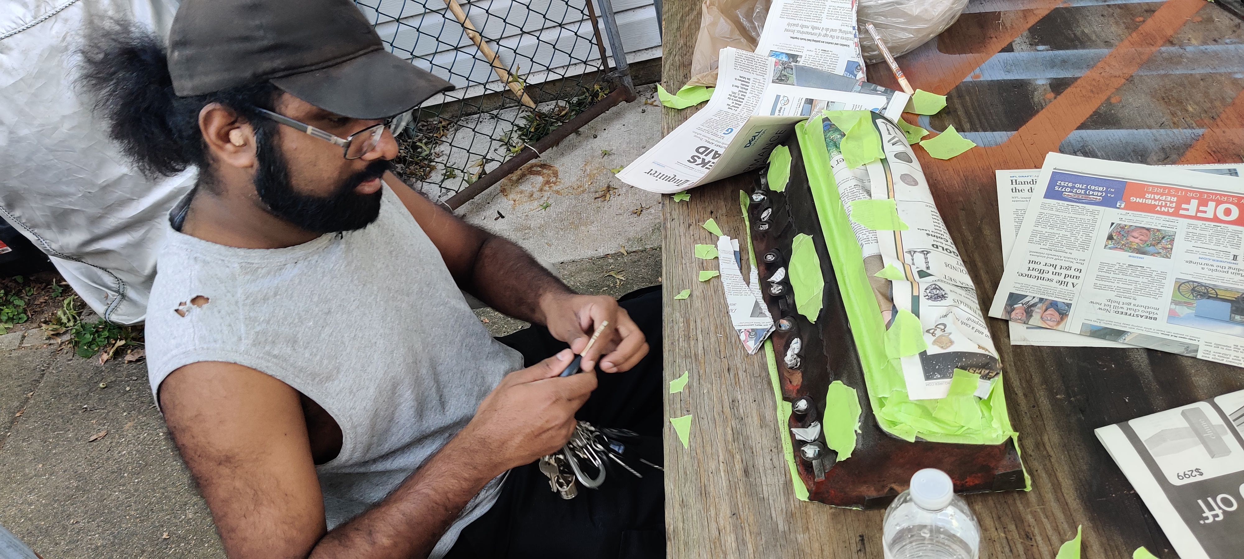 Stephen tapes up all surfaces that we don't want painted